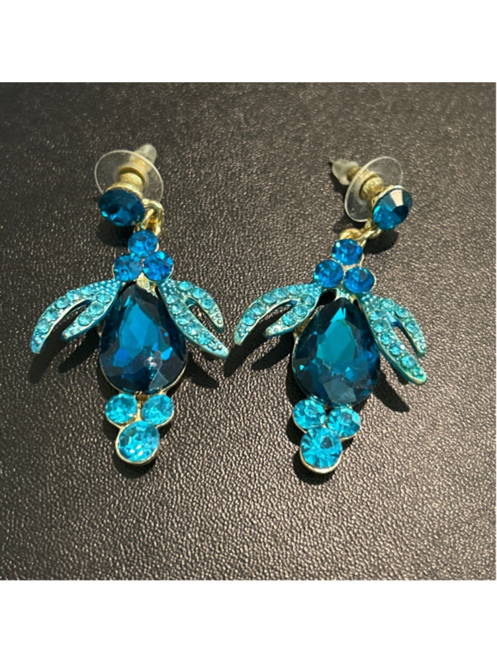 Women's blue rhinestone drop earrings featuring teal crystals
